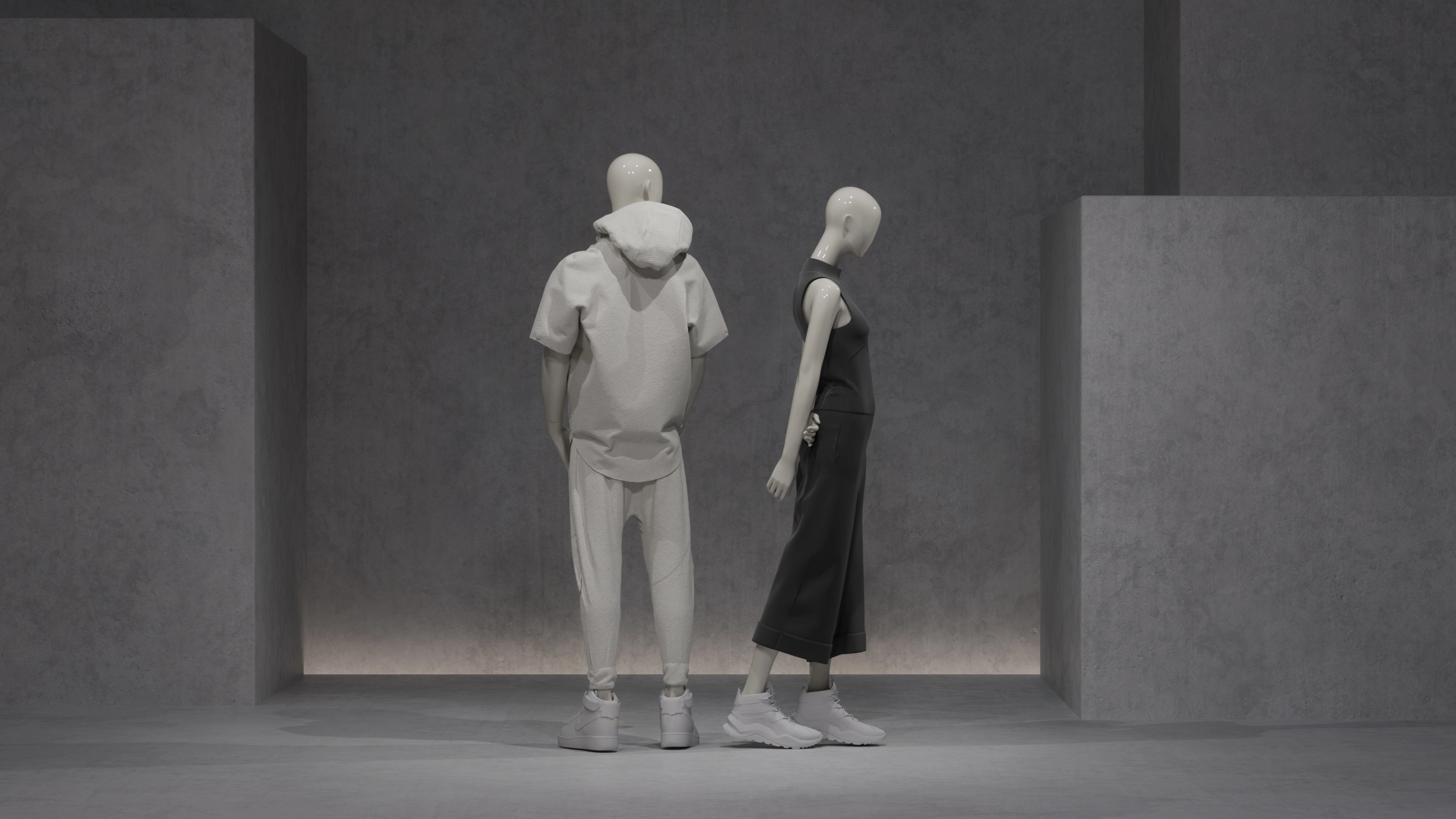 Male and female mannequins form the blend collection against a concrete background