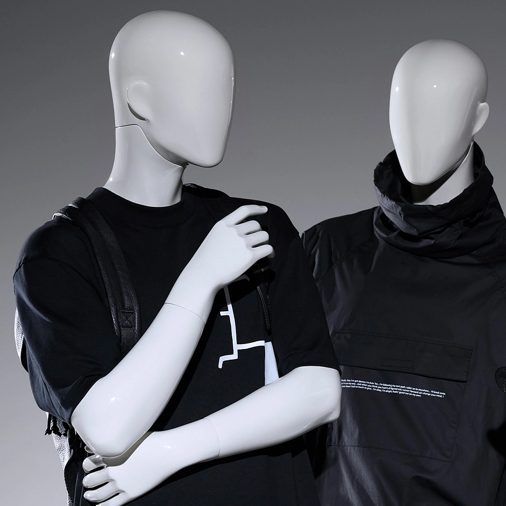 a pair of male mannequins from the blend collection looking at each other
