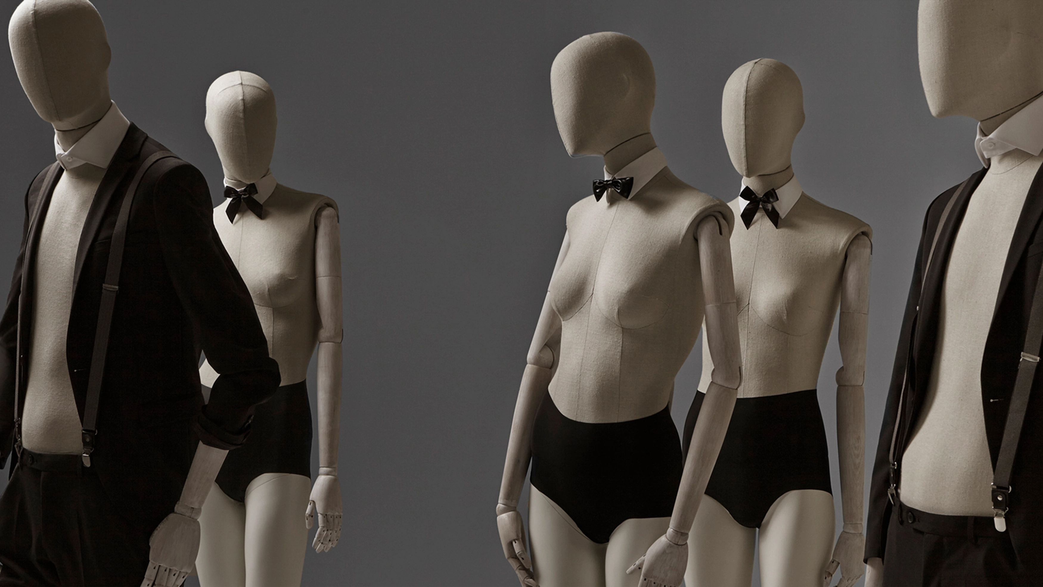 a group of female and male mannequins from the casual fabric collection wearing black shorts
