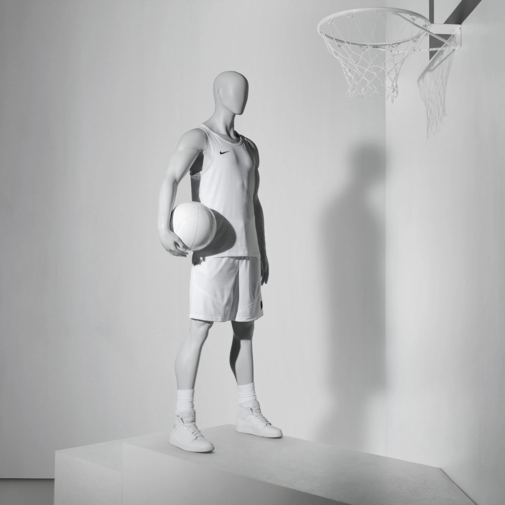 a male sport mannequin holding a basketball
